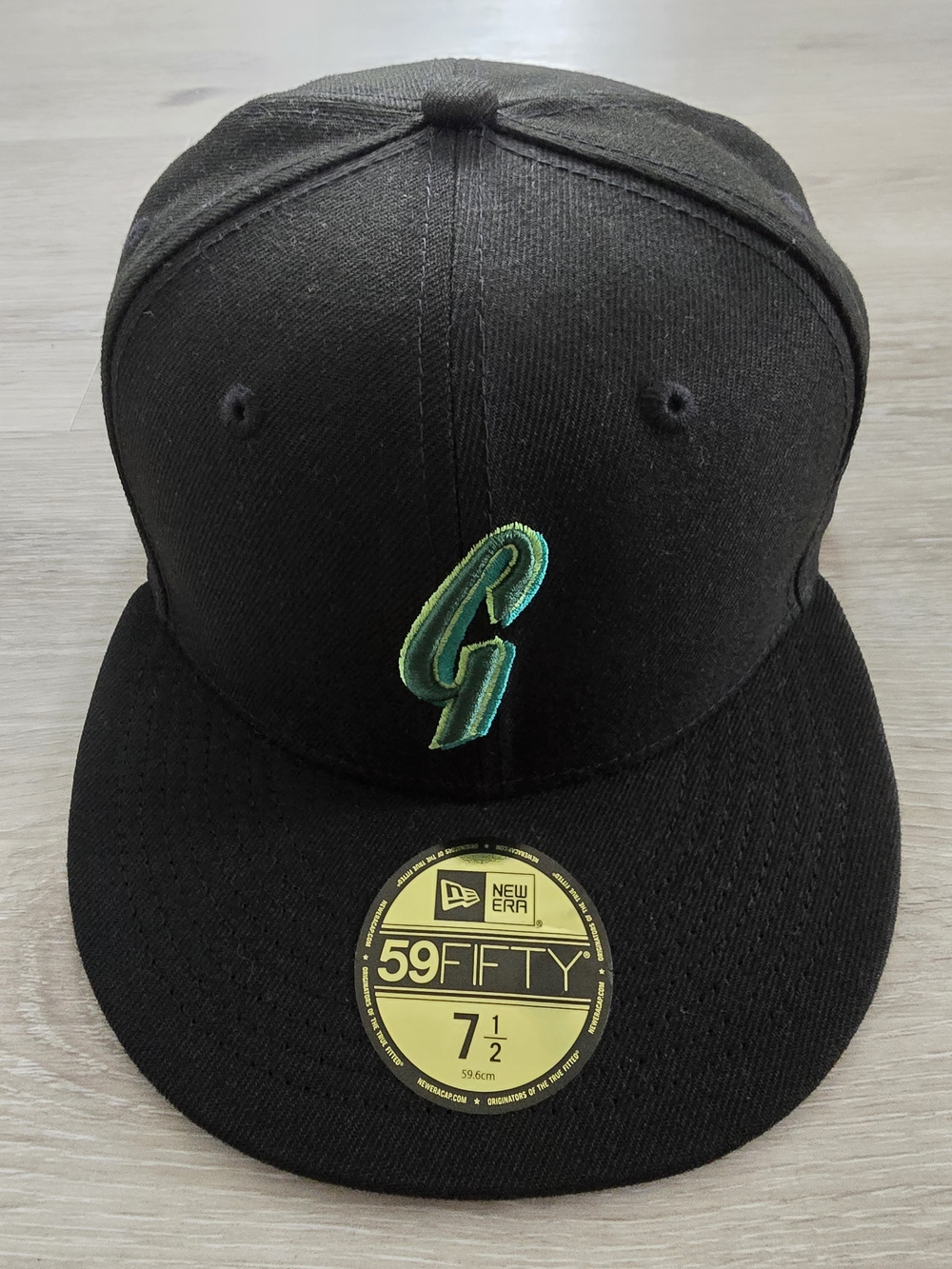 New Era 59FIFTY Black Fitted Cap with Green Embroidered Logo
